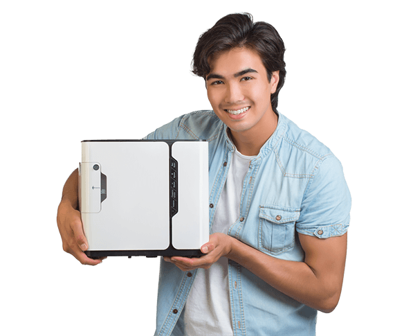 Young man holding a Restore oxygen concentrator