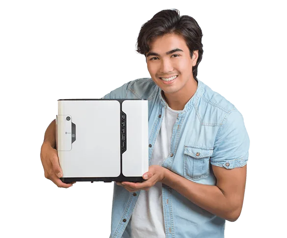 Young man holding a Restore oxygen concentrator